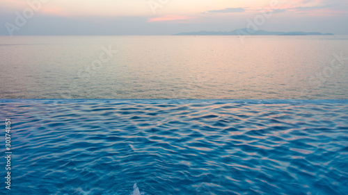 Swimming Pool with sunset on the sea
