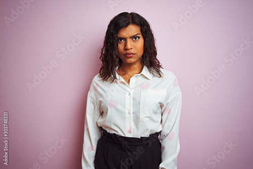 Transsexual transgender businesswoman standing over isolated pink background skeptic and nervous, frowning upset because of problem. Negative person.