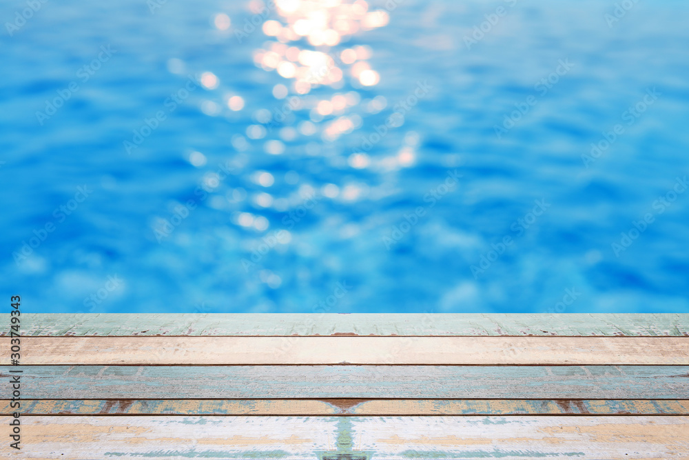 Wood table top on blur background of refraction in water Wood table top on blur background of refraction in water