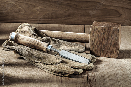 carpenter tools wooden mallet gloves and chisel photo