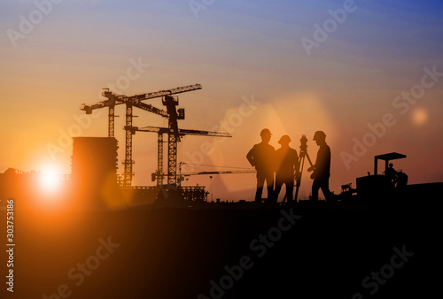 Silhouette of Survey Engineer and construction team working at site over blurred industry background with Light fair Film Grain effect.Create from multiple reference images together