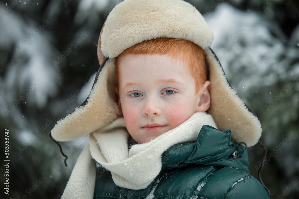 Red-haired boy is in the winter forest. Little forester. Red-haired boy is in the winter forest. Little forester.