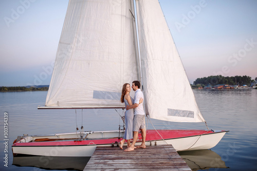 Couple in love on a yacht in sunny weather
