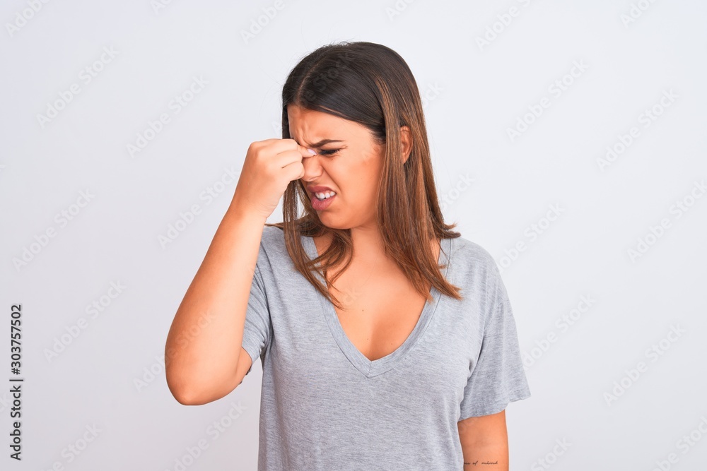 Portrait of beautiful young woman standing over isolated white background tired rubbing nose and eyes feeling fatigue and headache. Stress and frustration concept. Portrait of beautiful young woman standing over isolated white background tired rubbing nose and eyes feeling fatigue and headache. Stress and frustration concept.