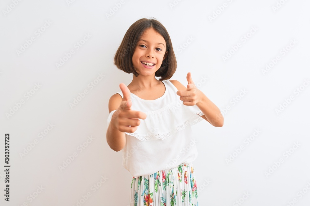 Young beautiful child girl wearing casual dress standing over isolated white background pointing fingers to camera with happy and funny face. Good energy and vibes. Young beautiful child girl wearing casual dress standing over isolated white background pointing fingers to camera with happy and funny face. Good energy and vibes.