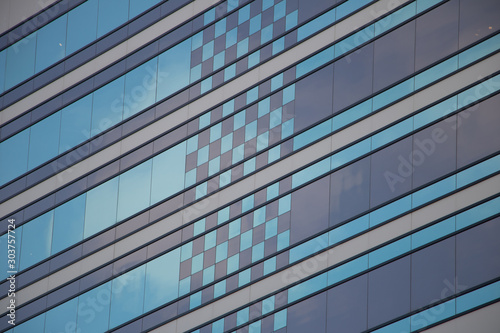 Blue patterned windows on side of building 
