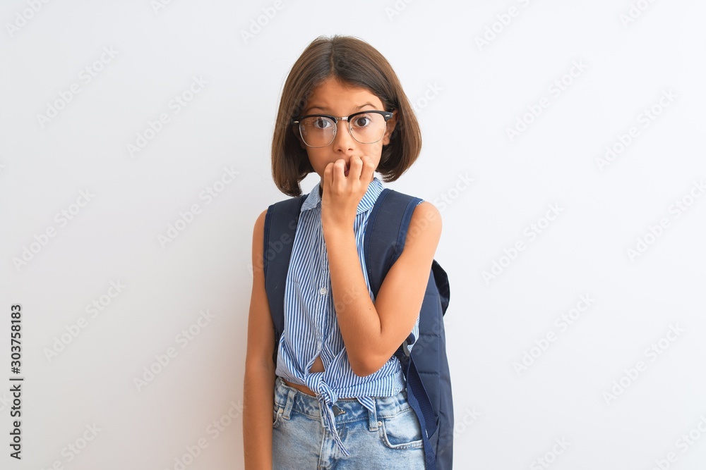 Beautiful student child girl wearing backpack and glasses over isolated white background looking stressed and nervous with hands on mouth biting nails. Anxiety problem. Beautiful student child girl wearing backpack and glasses over isolated white background looking stressed and nervous with hands on mouth biting nails. Anxiety problem.