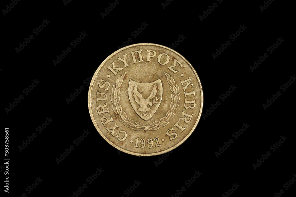 A close up image of an old five cent coin from Cyprus, shot close up in macro on a black background A close up image of an old five cent coin from Cyprus, shot close up in macro on a black background