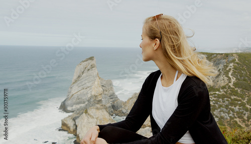 Sitting at the coast of Cabo da Roca in Portugal - travel photography photo