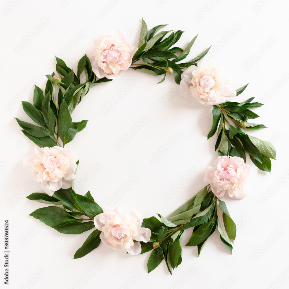 Wreath made of pink peonies and green leaves