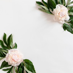 Frame made of pink peonies and green leaves