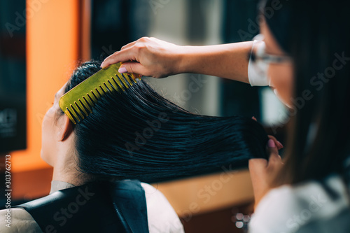 Hairdresser Brushing Woman’s Wet Hair