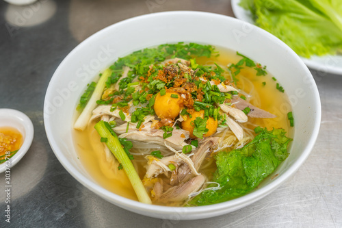 Bowl of delicious chicken pho noodle soup in Vietnamese restaurant