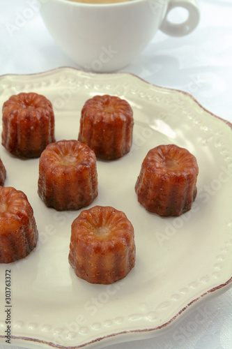 several cannelés on a plate	