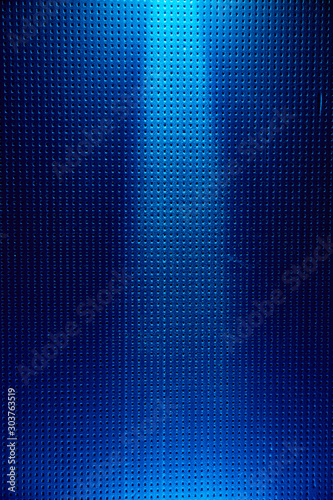 Bright blue and light blue dotted background with a white ray of light in the middle