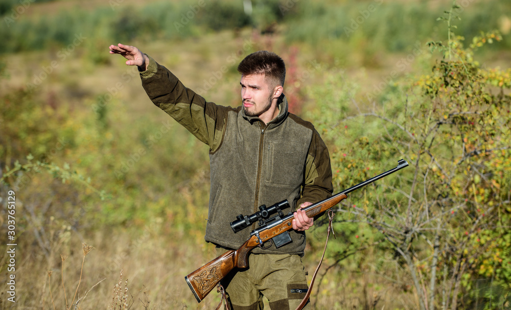 Look there. Noticed game. Man brutal unshaved gamekeeper nature background. Hunting permit. Hunting brutal masculine hobby. Hunting and trapping seasons. Bearded serious hunter spend leisure hunting Look there. Noticed game. Man brutal unshaved gamekeeper nature background. Hunting permit. Hunting brutal masculine hobby. Hunting and trapping seasons. Bearded serious hunter spend leisure hunting