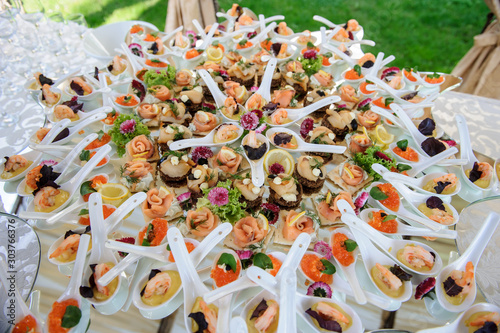 seafood canapes on a glass plate at a wedding cocktail