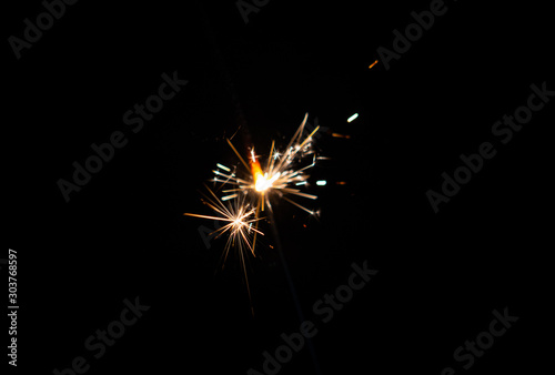 Lights of a sparkler with black background