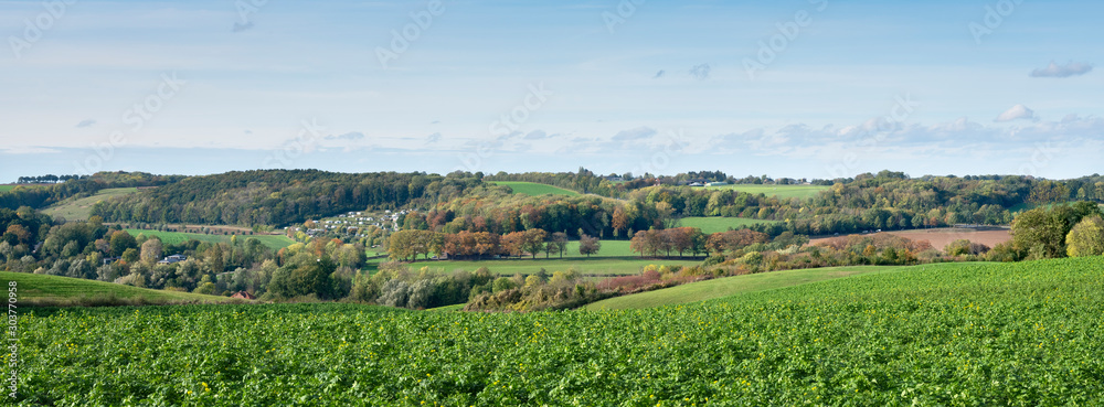 autumn landscape with fields and blue sky of south limburg in the netherlands under blue sky