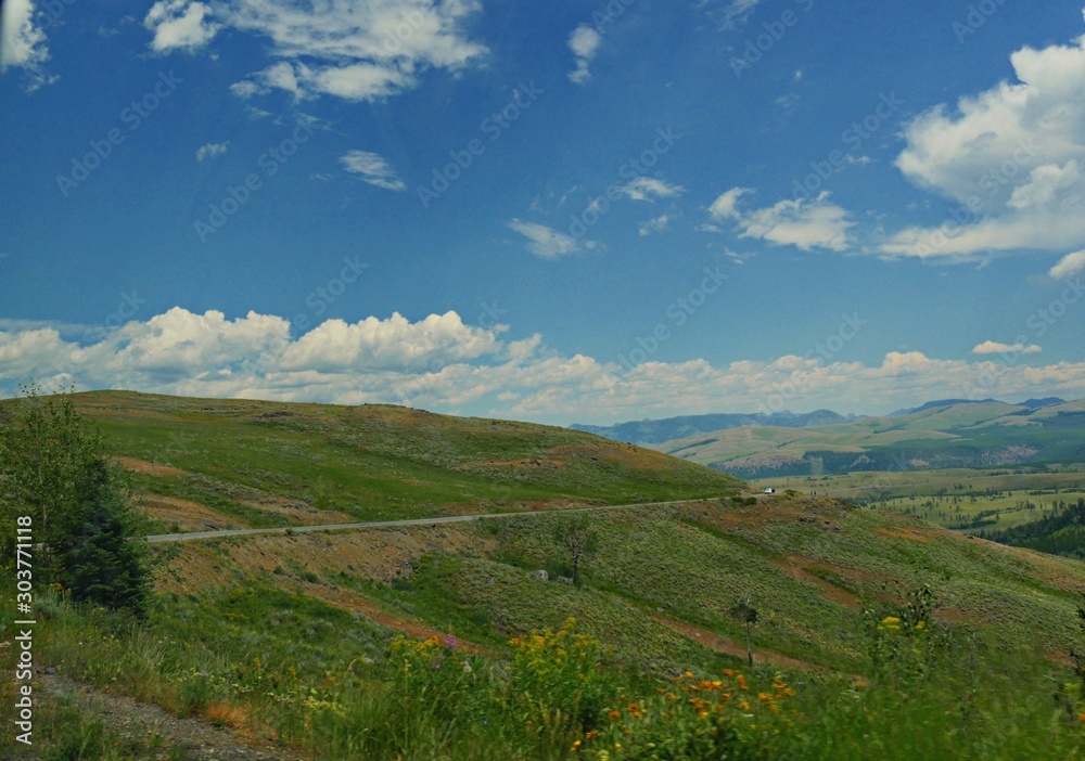 Scenic drive at Lamar Valley with beautiful clouds at Yellowstone National Park in Wyoming. Scenic drive at Lamar Valley with beautiful clouds at Yellowstone National Park in Wyoming.