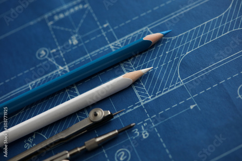 Drawing tools lying over blueprint paper photo