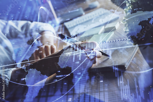 Financial forex charts displayed on woman's hand taking notes background. Concept of research. Double exposure