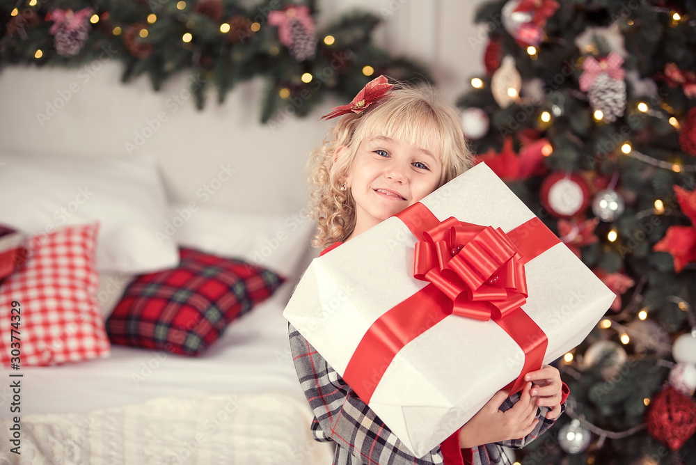Happy excited girl child holding christmas gift box. Happy excited girl child holding christmas gift box.