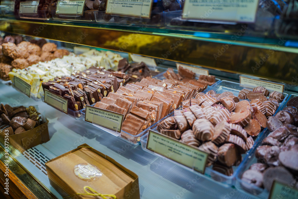 different types of chocolates  and sweets and their prices on display in the store