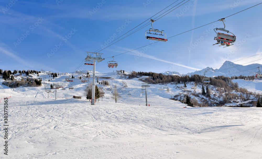 skiers on chairlifts in alpine resort at winter sports skiers on chairlifts in alpine resort at winter sports