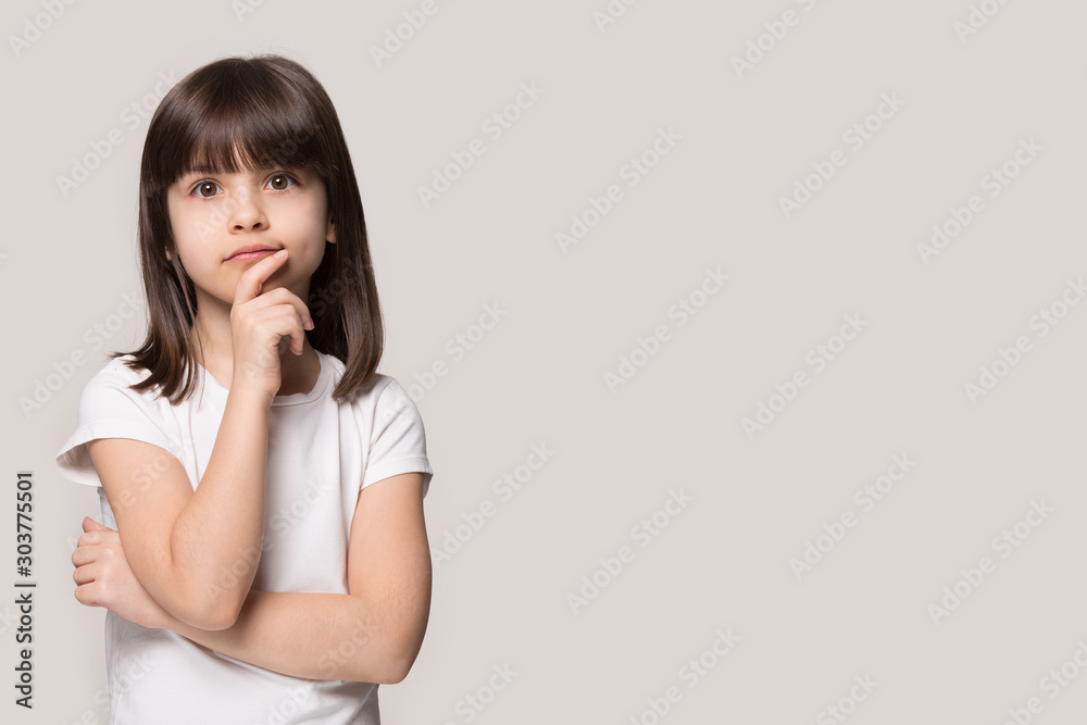 Close up portrait with thoughtful little brown-haired girl.