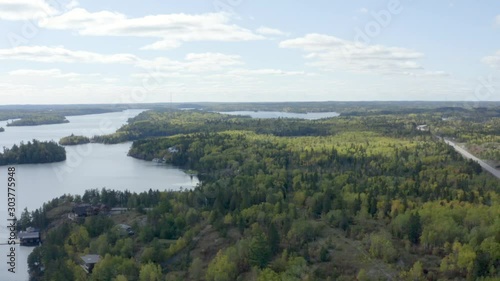 Aerial view, flying above lake and islands covered by pine trees, Kenora bay, lake of the woods, Ontario Canada. Panoramic 4k drone footage track in. photo