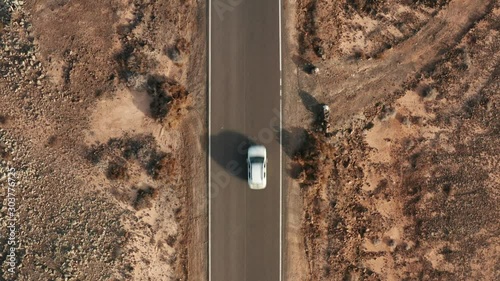 Desert road aerial with cars driving below high shot