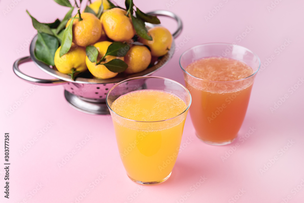 Composition with Two Glasses of Assorted Citrus Juices Detox Diet Healthy Drink Mandarine Lemon and Grapefruit Juices Raw Mandarines Pink Background Horizontal Composition with Two Glasses of Assorted Citrus Juices Detox Diet Healthy Drink Mandarine Lemon and Grapefruit Juices Raw Mandarines Pink Background Horizontal