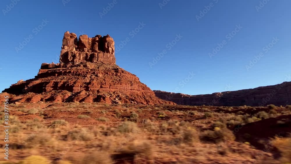 Driving past the amazing rock formations of the Valley of the Gods in Southern Utah Driving past the amazing rock formations of the Valley of the Gods in Southern Utah