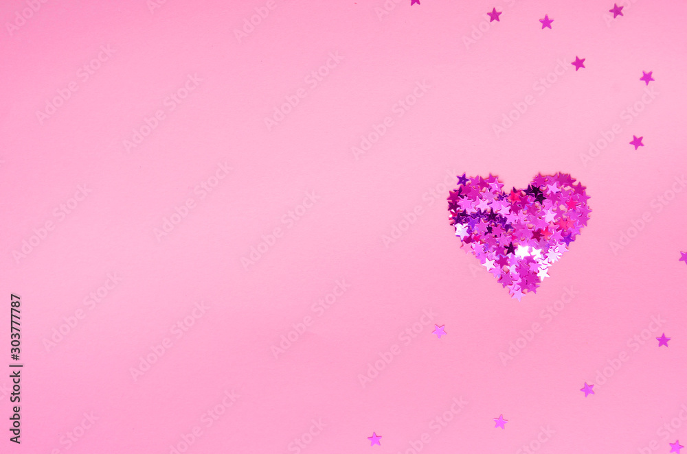 Pink glittering heart made of small stars on a light pink background. Valentines Day card. Top view. Flat lay. Copy space