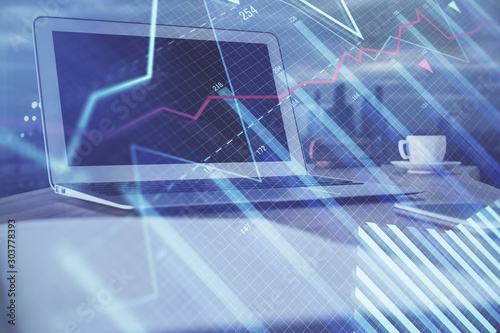 Stock market graph and table with computer background. Multi exposure. Concept of financial analysis.