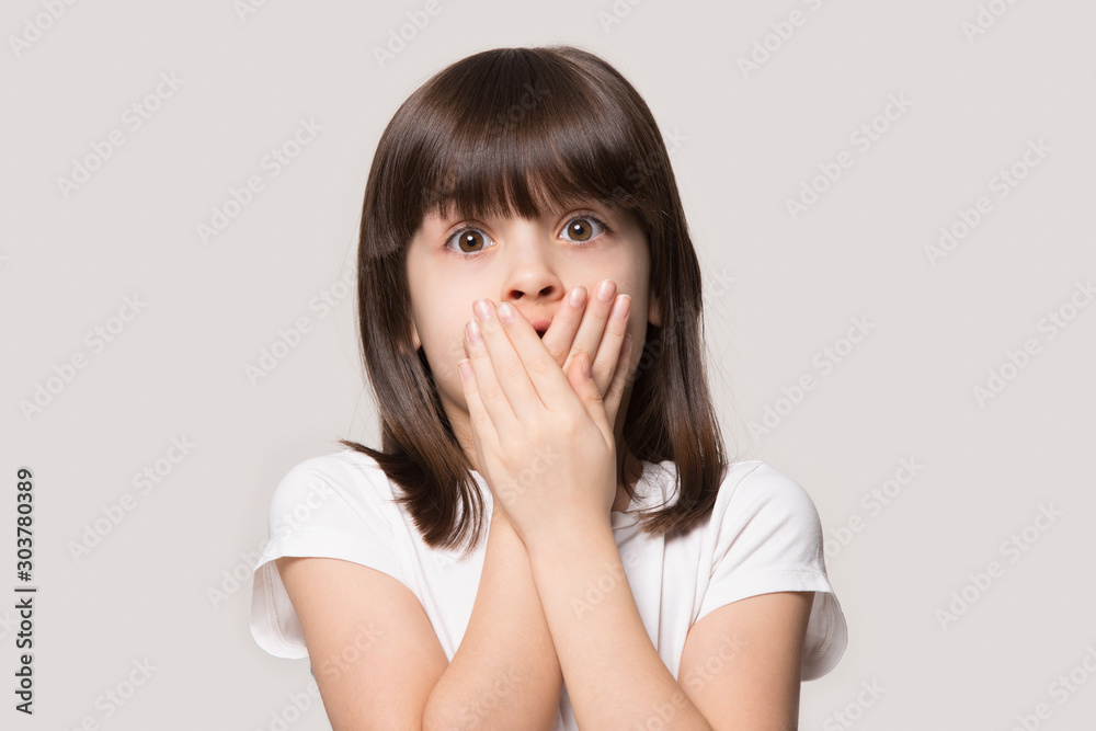 Close up portrait with scared little brown-haired girl. Close up portrait with scared little brown-haired girl.