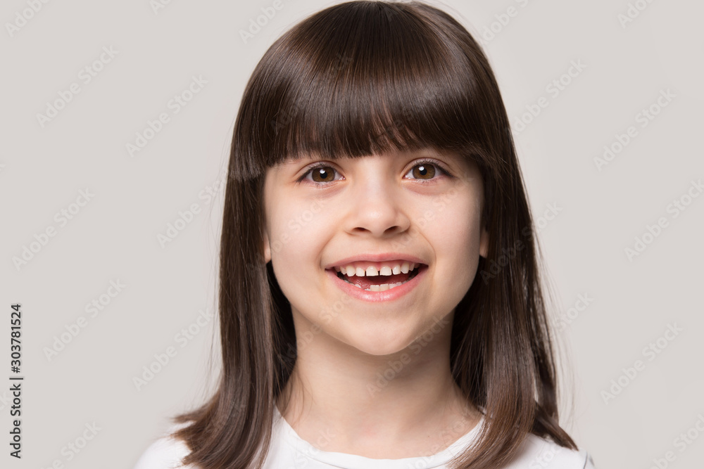 Close up portrait with smiling little brown-haired girl Close up portrait with smiling little brown-haired girl