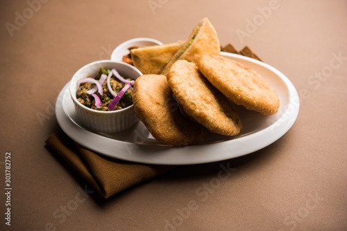 Fried Sattu Litti chokha served with Baingan Bharta, onion and pickle, popular recipe from Bihar, India photo