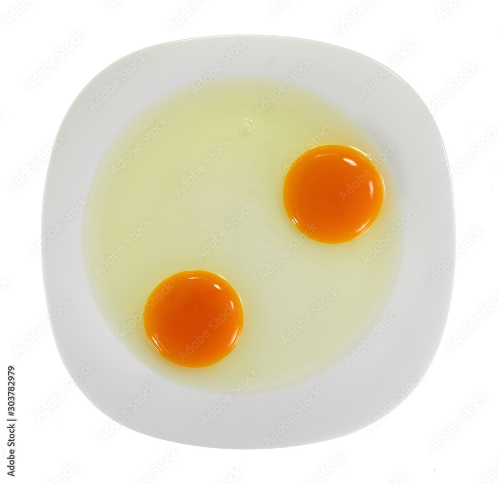 Two uncooked eggs in a white plate isolated on white background