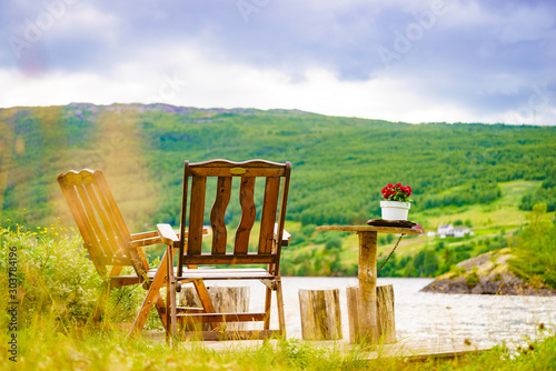 Rest stop area picnic chaires on fjord lake shore photo