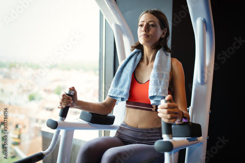 Beautiful fit young woman training in gym