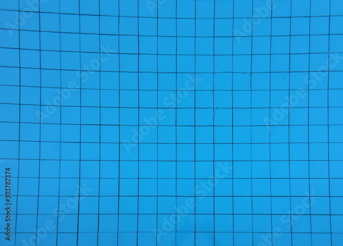 The mosaic swimming pool bottom with blue clear water.