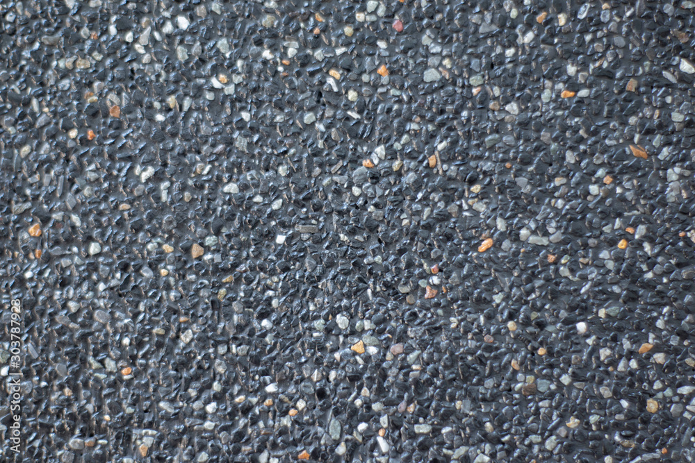 The polished stone walls are mixed with black and white small stones coated with wax. As a background and arrangement pattern of stone beads The polished stone walls are mixed with black and white small stones coated with wax. As a background and arrangement pattern of stone beads