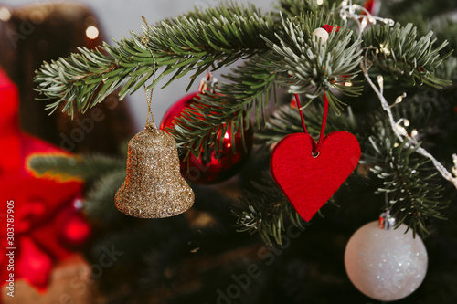 Christmas tree with different ornaments and lights. Close up image.