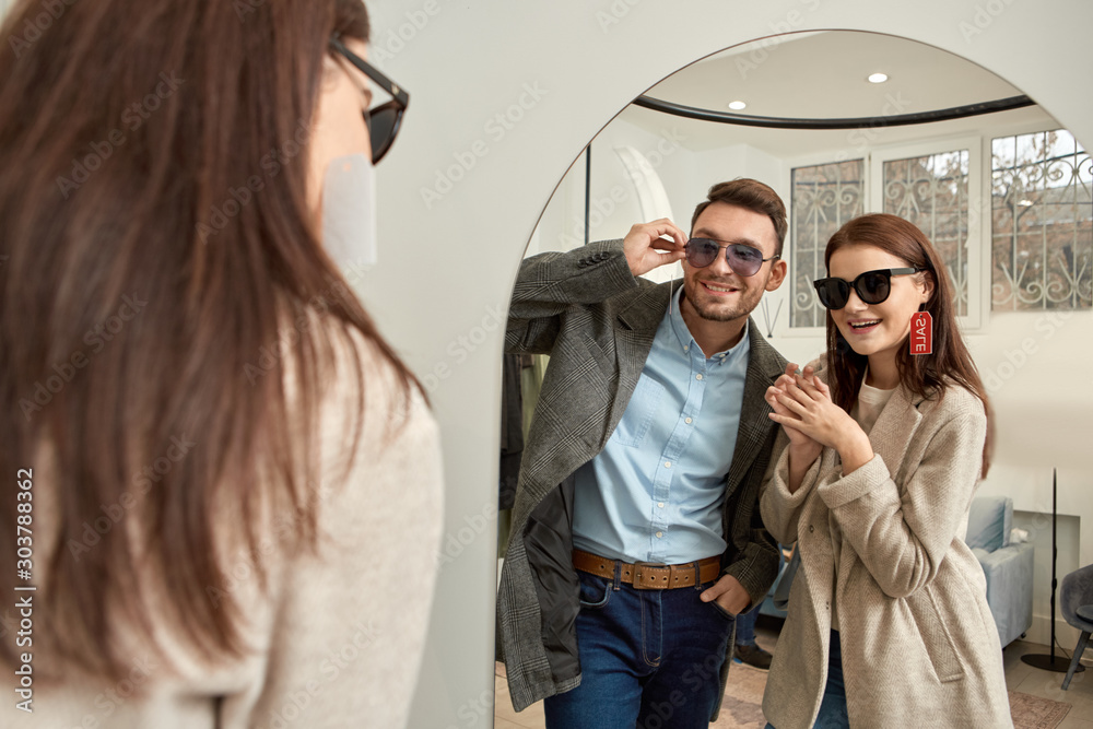 Fototapeta premium Adult woman and man wearing sunglesses and smiling nice
