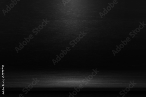 Black table in the dark background. 