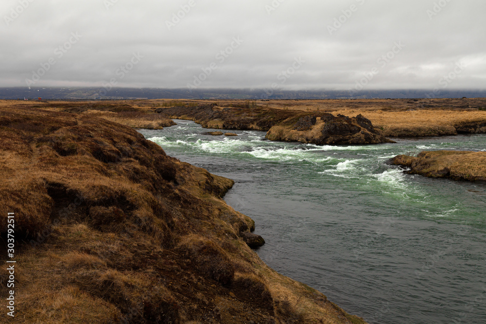 River and stunted grass on a dramatic landscape of Iceland
