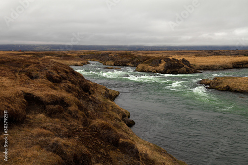 River and stunted grass on a dramatic landscape of Iceland © strannik_fox