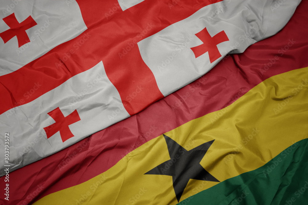 Fototapeta premium waving colorful flag of ghana and national flag of georgia.